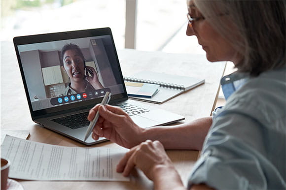 two women video chatting on a computer 