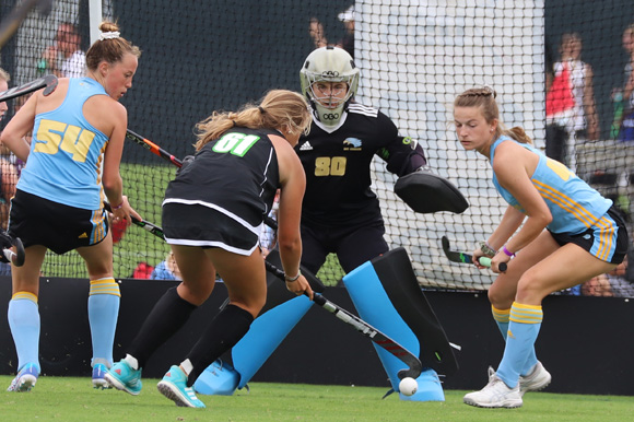 Teens playing field hockey