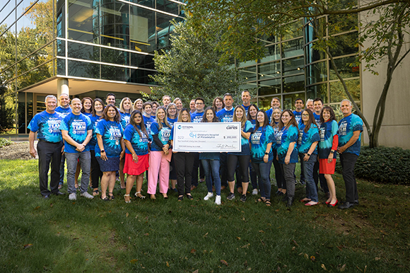 Citadel employees group photo holding a check presented to CHOP