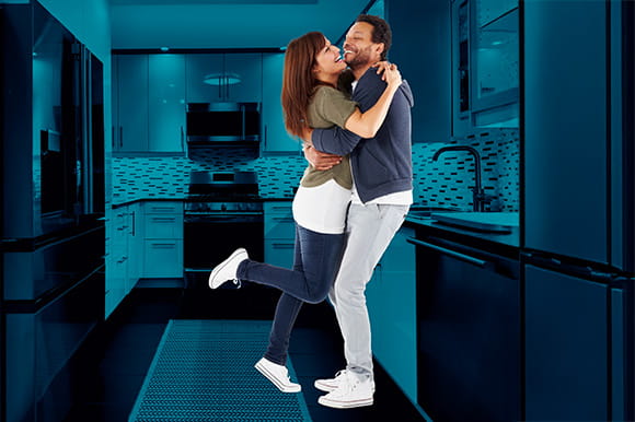 A couple dancing in a kitchen