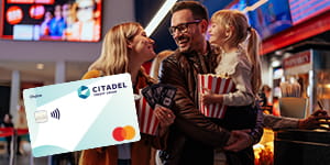 A mom, dad and daughter walking though a movie theater