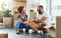 Couple sitting on the floor of a new home