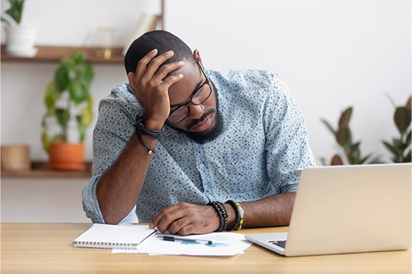 Concerned man checking his accounts on his computer