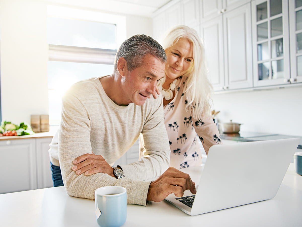 Older couple viewing tax information on a laptop