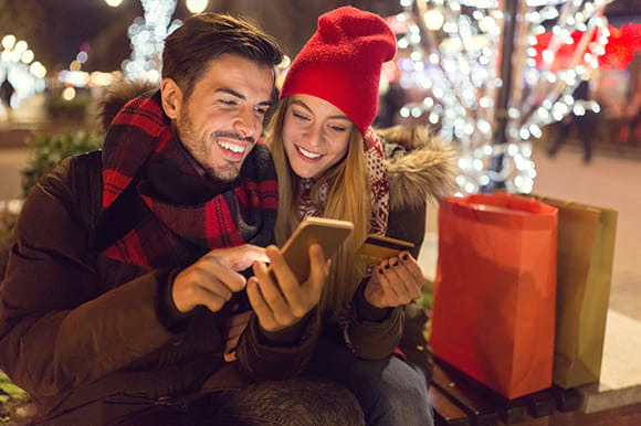 Couple shopping while looking at a phone