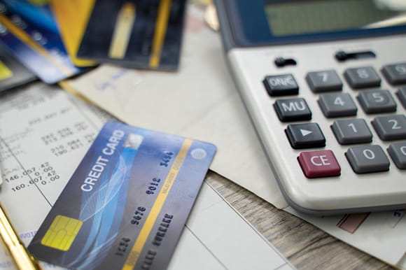 A credit card sitting on top of bills