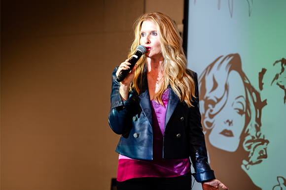 Woman presenting on stage