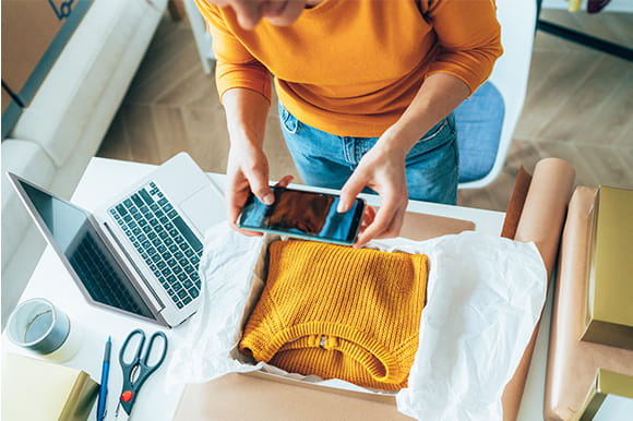 person photographing items to sell