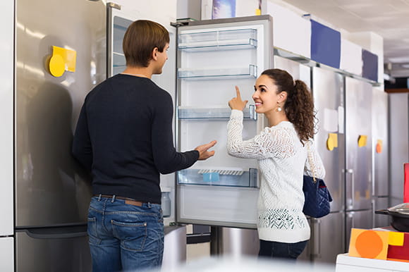 A couple shopping for a refrigerator