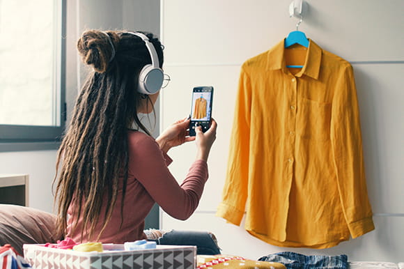 Woman taking a photo of a shirt to sell