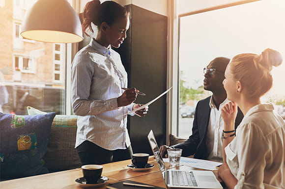 Small business owners sitting with a banking representative
