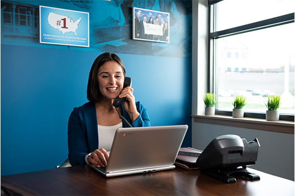 woman working at a desk on the phone 